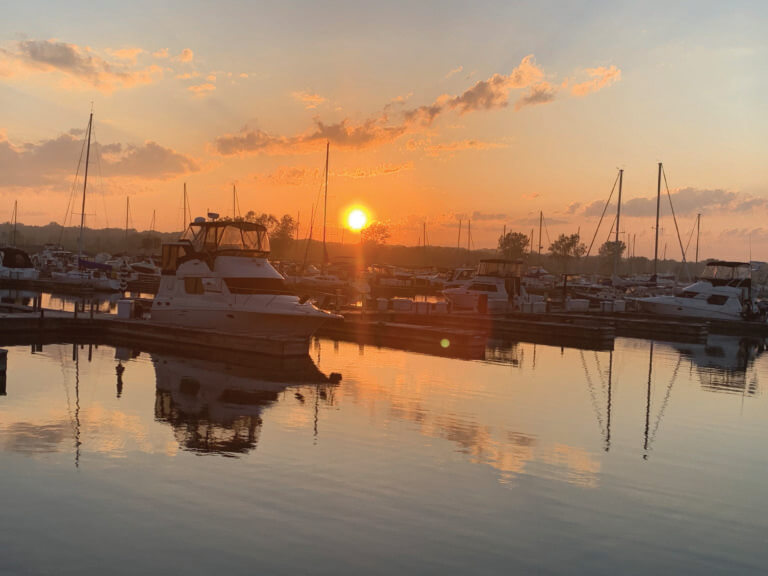 Sun setting behind wet boat slips at North Point Marina
